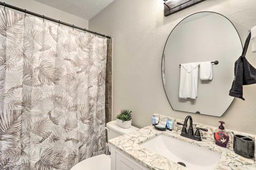 a bathroom with a shower curtain and a sink at Pet-Friendly Gulfport Home Less Than 2 Mi to Beach in St Petersburg