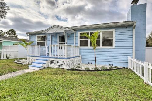 a blue house with a palm tree in the yard at Pet-Friendly Gulfport Home Less Than 2 Mi to Beach in St Petersburg