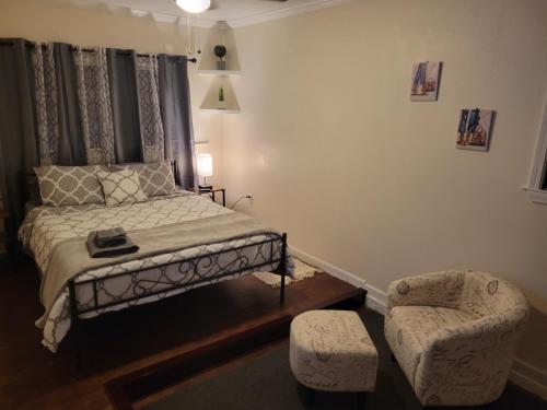 a small bedroom with a bed and a chair at Large Spacious Bedroom with Private Entrance Females Only in Westwego