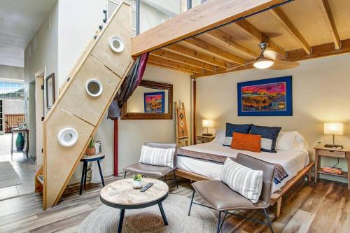 a bedroom with a bed and a staircase in it at The Owl's Nest @ Manitou: Mtn Views on Main Street in Manitou Springs