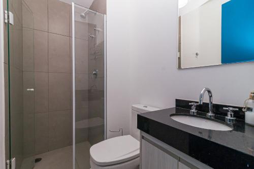 a bathroom with a toilet and a sink and a shower at Vossa Bossa VN Turiassu in Sao Paulo