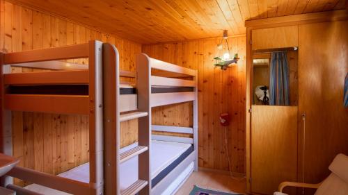 a room with two bunk beds in a cabin at Maxima in Fiesch
