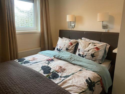 ザントフォールトにあるEllaの花柄の掛け布団と枕2つが備わるベッド1台