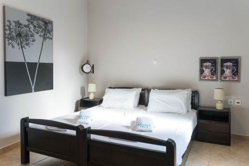 a bedroom with a large bed with two night stands at Belleza Villa in Lixouri