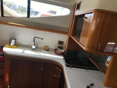 a kitchen with a sink and a window at yatch for rent izmir cesme 3 camaras kiralik yat in Ildır