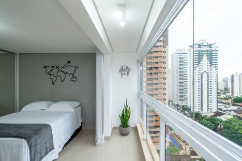 a bedroom with a bed and a balcony at THE EXPRESSION BUENO in Goiânia