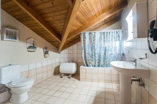 a bathroom with a toilet and a sink at Belleza Villa in Lixouri