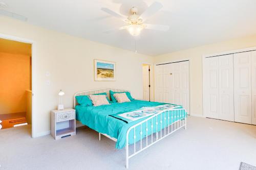 a bedroom with a bed and a ceiling fan at Salt Pond --- 31962 Topsail Court Unit 7 in Bethany Beach