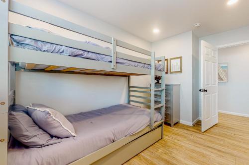 a bedroom with two bunk beds and a hallway at Town of South Bethany --- 108 Brandywine Dr in Bethany Beach