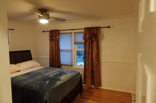a bedroom with a bed and a window at Handsome Home - 4 minutes close to Metro in Lanham