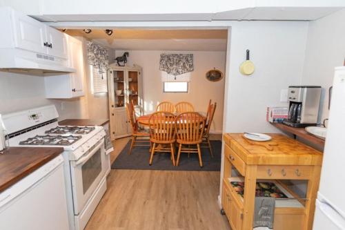 a kitchen and dining room with a table and chairs at Cozy & Comfy Cottage in the City - w parking in Pittsburgh