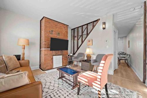a living room with a couch and a fireplace at Hip and Bright Lawerenceville 2 Bed Easy Parking in Pittsburgh
