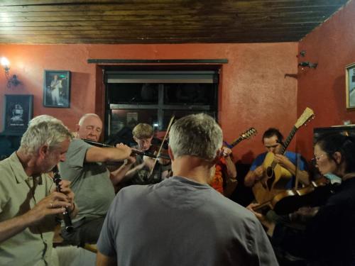 a group of people playing instruments in a room at The Valley House in Valley
