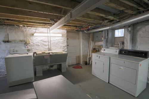 a kitchen with white appliances in a room at Stylish and Refined with Easy City Access in Pittsburgh