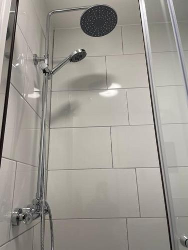 a shower with a glass door in a bathroom at Modern Apartment With En-suite & Private Kitchen in Stoke on Trent