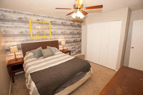 a bedroom with a bed and a ceiling fan at Hip & Cozy to Explore the City or Catch a Game in Pittsburgh