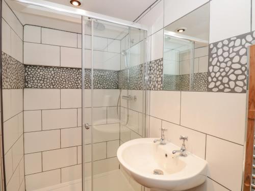 a white bathroom with a sink and a shower at 19 Above Town in Dartmouth