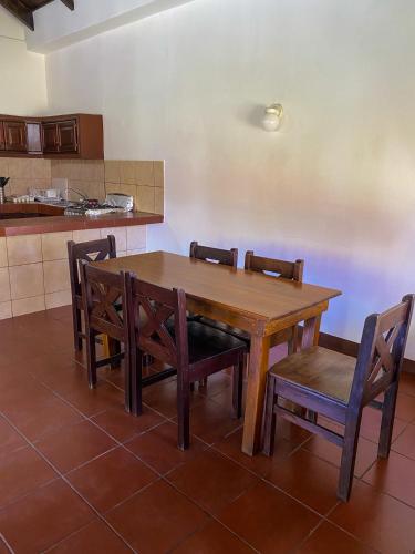 a wooden table and chairs in a kitchen at HOTEL UTZTZABA in Monterrico