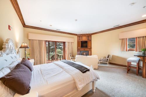 a bedroom with a large bed and a living room at Stock Farm Inn in Hopland