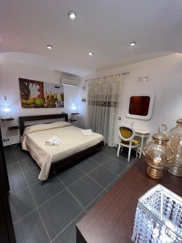 - une chambre avec un lit, une table et une télévision dans l'établissement Nel Cortile Suite, à Cefalù