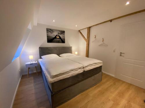 a bedroom with a bed with a picture on the wall at Ferienwohnung Luxusblick in Bad Harzburg