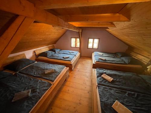 a attic room with three beds in it at Chalupa U Kocourka in Sedlec