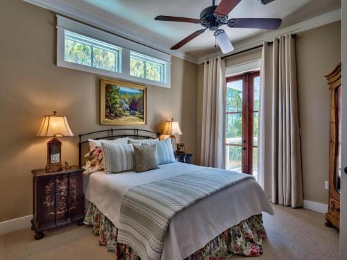 a bedroom with a bed and a ceiling fan at Southern Grounds in Santa Rosa Beach
