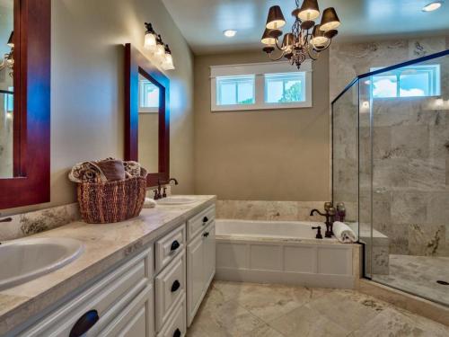 a bathroom with a tub and a sink and a shower at Southern Grounds in Santa Rosa Beach