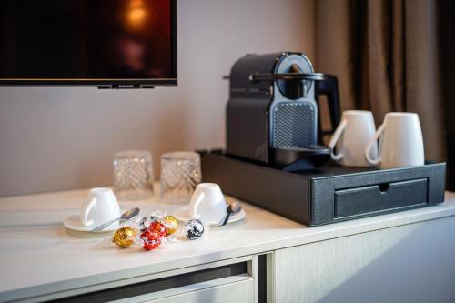 a table with a coffee maker and some food on it at Your Stay in Bolzano in Bolzano