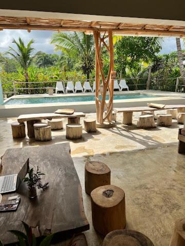 a patio with a table and chairs and a pool at Residencia El Balatà in Las Terrenas