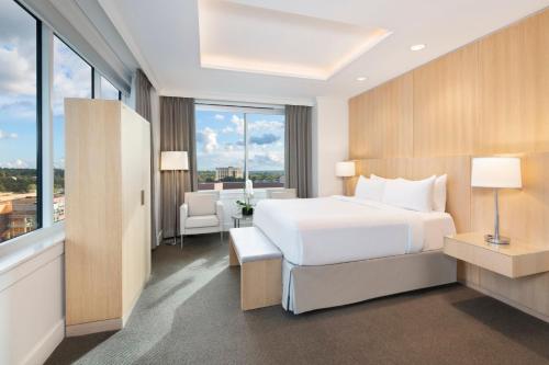 a bedroom with a white bed and a large window at InterContinental Cleveland by IHG in Cleveland