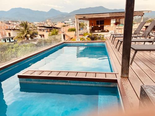 a swimming pool on the roof of a house at Hotel Central in Tarapoto