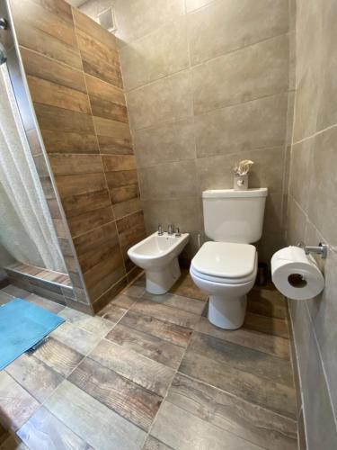 a bathroom with a toilet and a sink at CDC Ambientes - Alojamiento Temporario in Rada Tilly