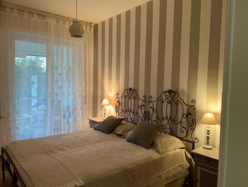 a bedroom with a large bed and a window at Sanremo Collection I in Sanremo