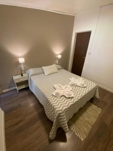 a bedroom with a bed with two towels on it at CDC Ambientes - Alojamiento Temporario in Rada Tilly