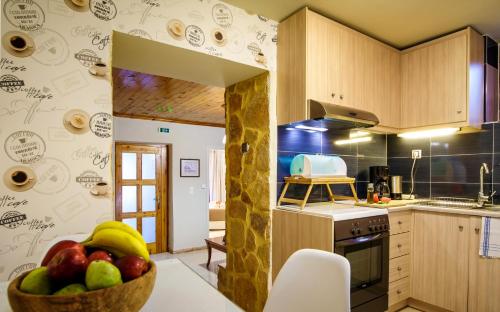 a kitchen with a bowl of fruit on the counter at AnnaView Apartments & Suites in Plakias