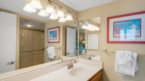 a bathroom with a sink and a mirror at Beachcrest 903 in Santa Rosa Beach