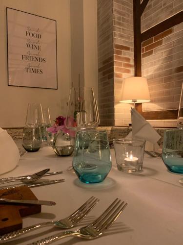 a table with glasses and silverware on a white table cloth at Gasthaus Neue Mühle in Westhausen