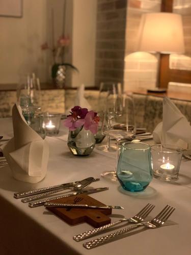 a table with a white table cloth with silverware at Gasthaus Neue Mühle in Westhausen