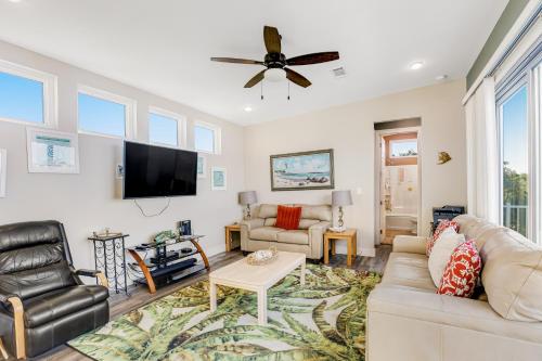 a living room with a couch and a flat screen tv at Big Pine Key Dreams in Big Pine Key