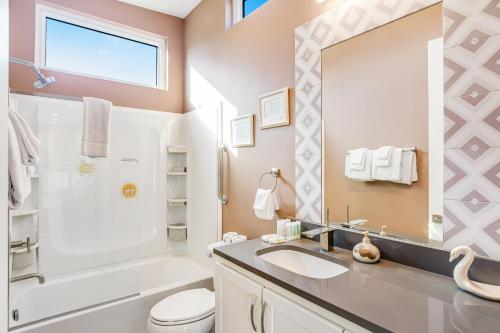 a bathroom with a sink and a toilet and a mirror at Big Pine Key Dreams in Big Pine Key