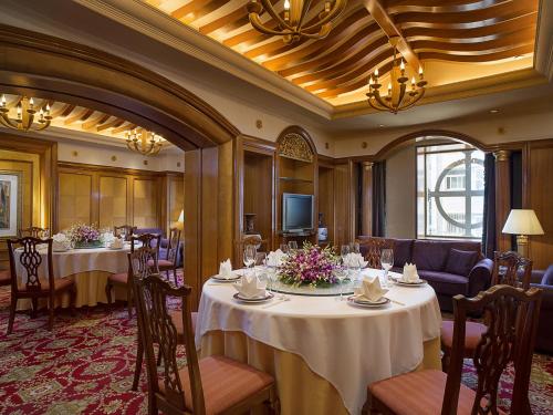 a conference room with tables and chairs and a television at Celebrity International Grand Hotel in Beijing