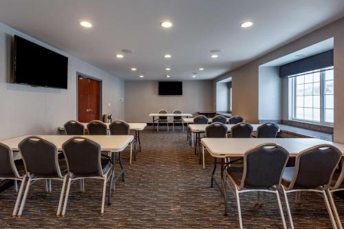 a conference room with tables and chairs and a flat screen tv at Best Western Plus Woodstock Inn & Suites in Woodstock
