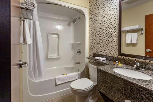 a bathroom with a toilet and a sink and a shower at Best Western Plus Woodstock Inn & Suites in Woodstock