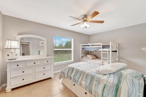 a bedroom with a bed and a dresser and a mirror at Englewood Relaxation in Englewood