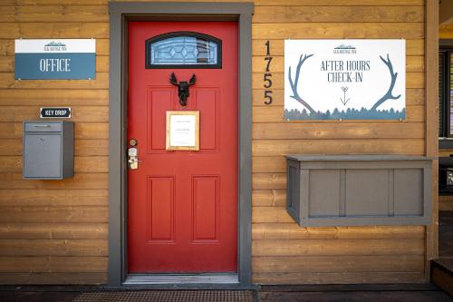 a red door on a building with a sign on it at Elk Refuge Inn in Jackson