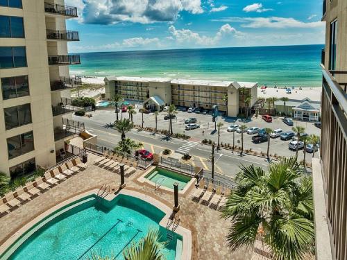 an aerial view of a hotel with a pool and the beach at Origin at Seahaven in Panama City Beach