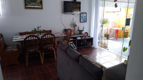 a living room with a couch and chairs and a table at Brisa do Mar Guaratuba in Guaratuba
