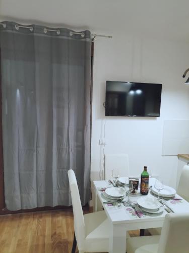a white dining room table with white chairs and a white table and chairsktop at Belvedere Zlatibor LUX & SPA Apartment in Zlatibor