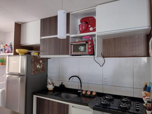a kitchen with a sink and a refrigerator at AP Maria Farinha in Paulista